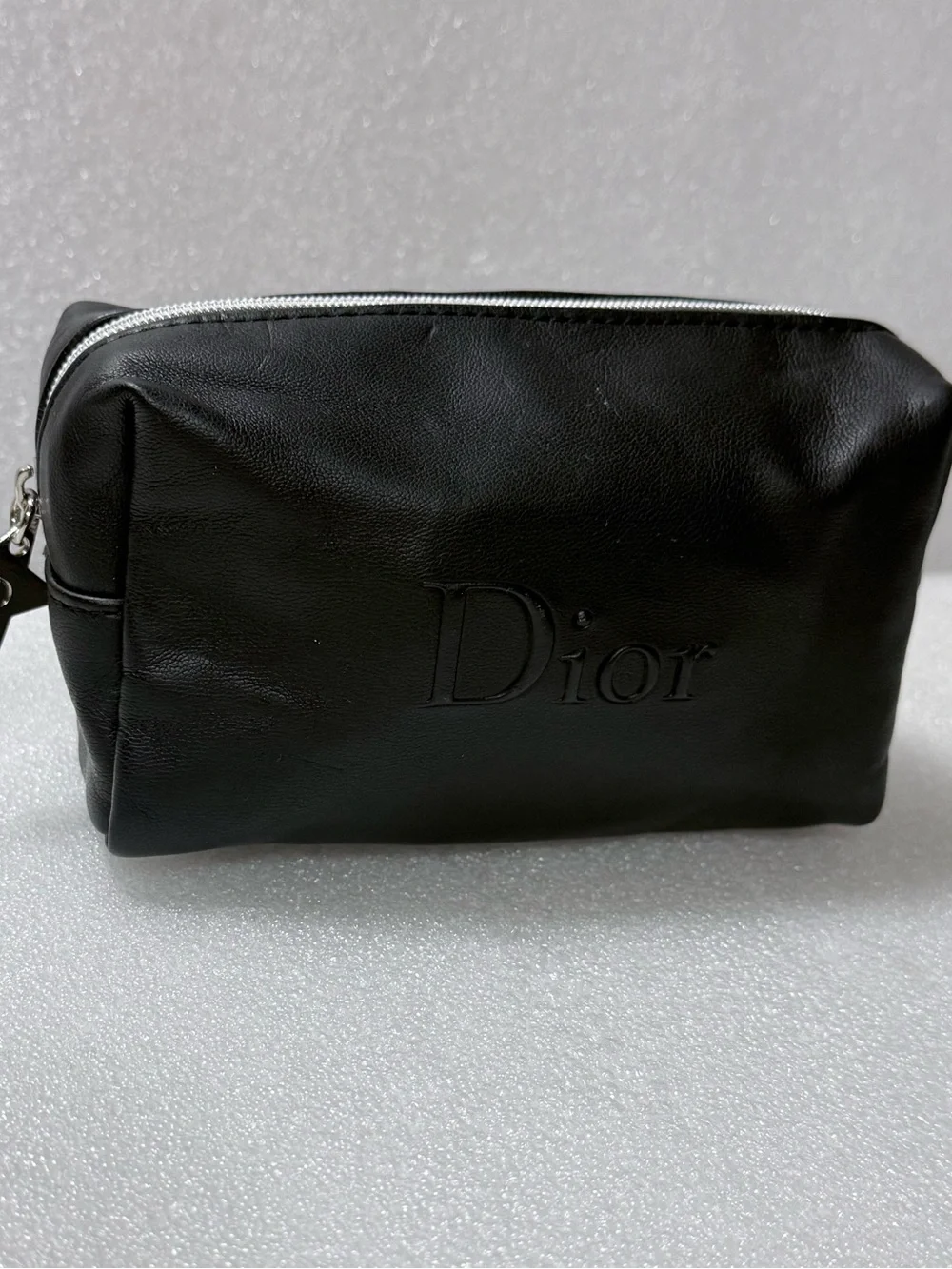 Dior makeup bag features a black exterior